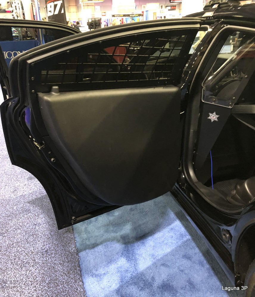 DC9502-DC A modified car door interior with a large black protective panel and a mesh screen, displayed in a showroom.